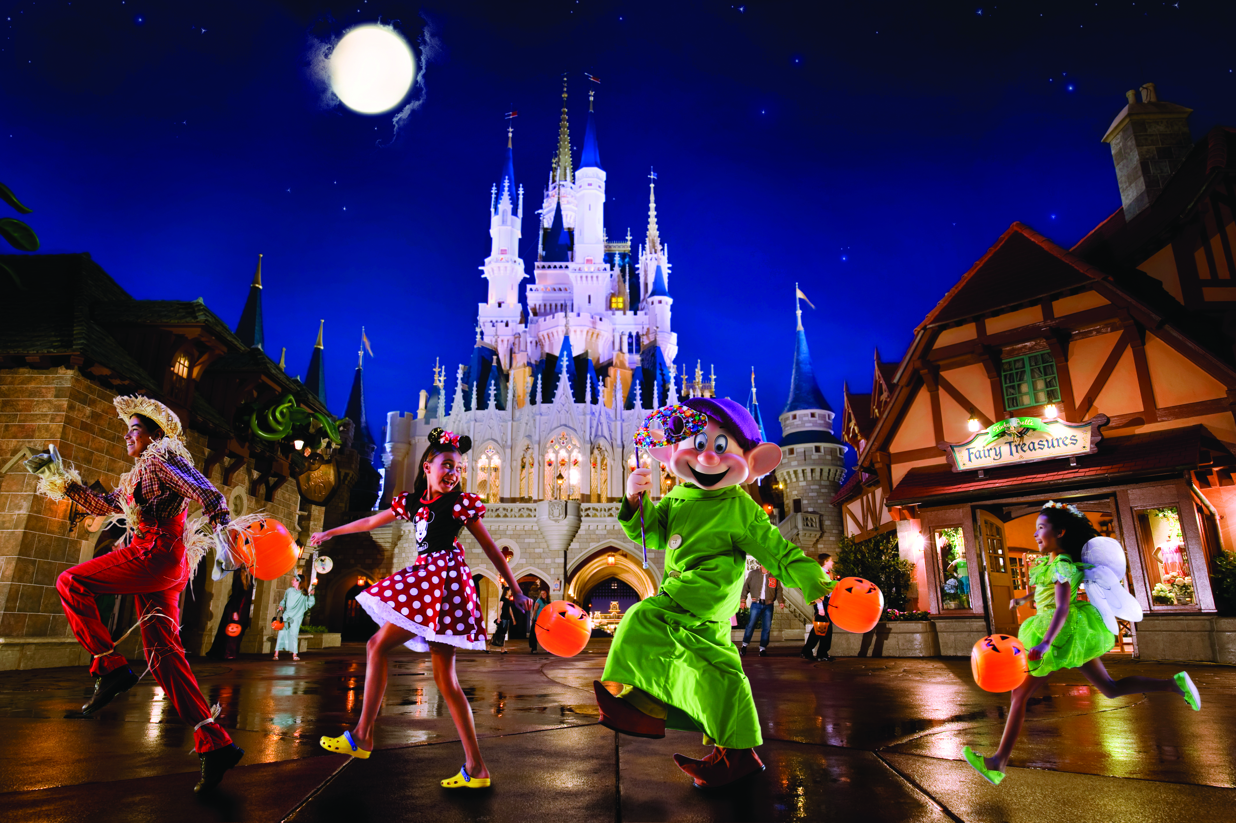 Girl dressed up in Minnie Mouse costume marking with her Halloween pail marching with Disney characters and other kids behind Cinderella's Castle at Magic Kingdom.