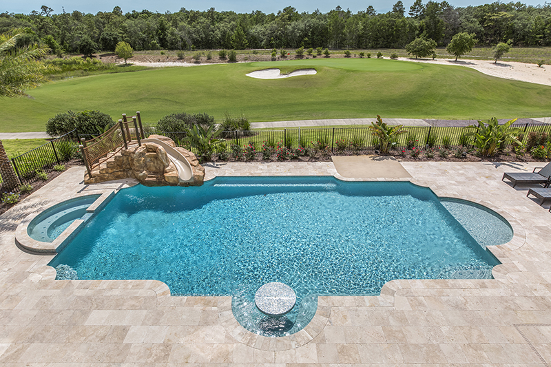 Magical Vacation Homes rental with a private pool with slide and golf course view in Reunion Resort property. Daytime shot.