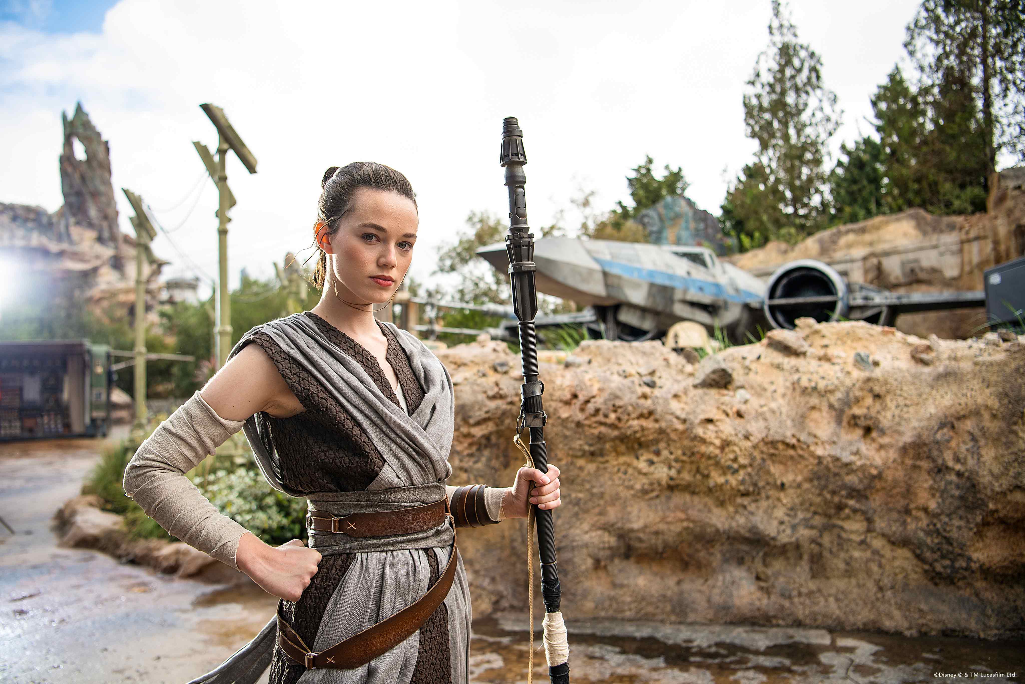 Rey posing for the photo during the daytime in Batuu inside of Star Wars: Galaxy's Edge at Disney's Hollywood Studios®. Lake Buena Vista, Florida.