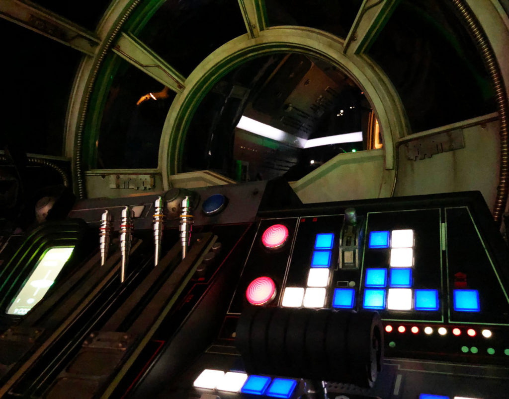 A close-up photo of a lit up cockpit prior to to the start of the attraction for Millennium Falcon: Smugglers Run inside of Star Wars: Galaxy's Edge. Disney's Hollywood Studios®, Lake Buena Vista, Florida.