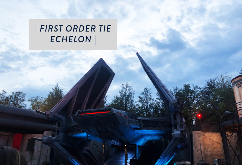 he First Order ship in a daytime shot lit in red and blue with boxed text in top left corner that reads "First Order Tie Echelon" inside of Star Wars: Galaxy's Edge at Disney's Hollywood Studios®. Lake Buena Vista, Florida.