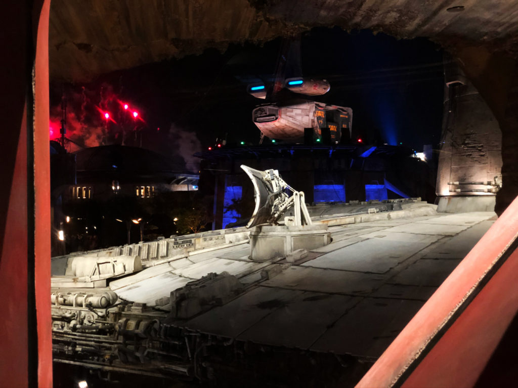 Nighttime view in queue behind glass of the Millennium Falcon inside of Star Wars: Galaxy's Edge at Disney's Hollywood Studios®. Lake Buena Vista, Florida.