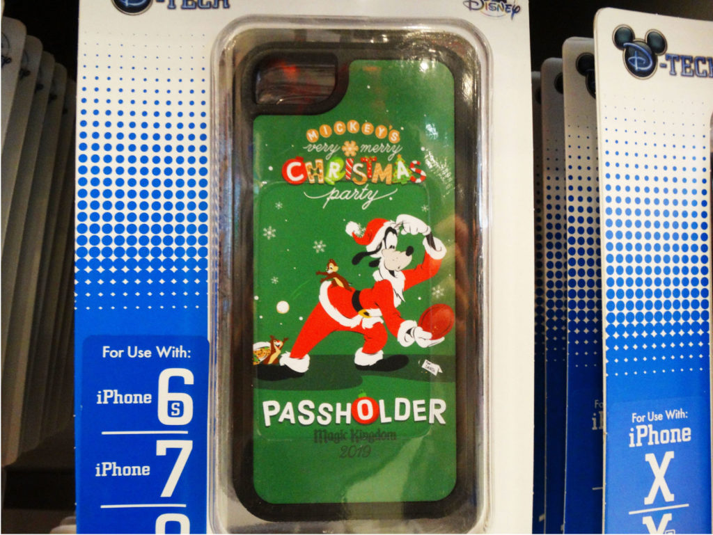 Limited release iPhone Case for Mickey's Very Merry Christmas Party 2019. Passholder exclusive. Green case with graphic of Goofy dressed as Santa Clause and looking at his reflection in a mirror. Name of event is printed above him. "Passholder Magic Kingdom 2019" is printed below him. Lake Buena Vista, Florida.