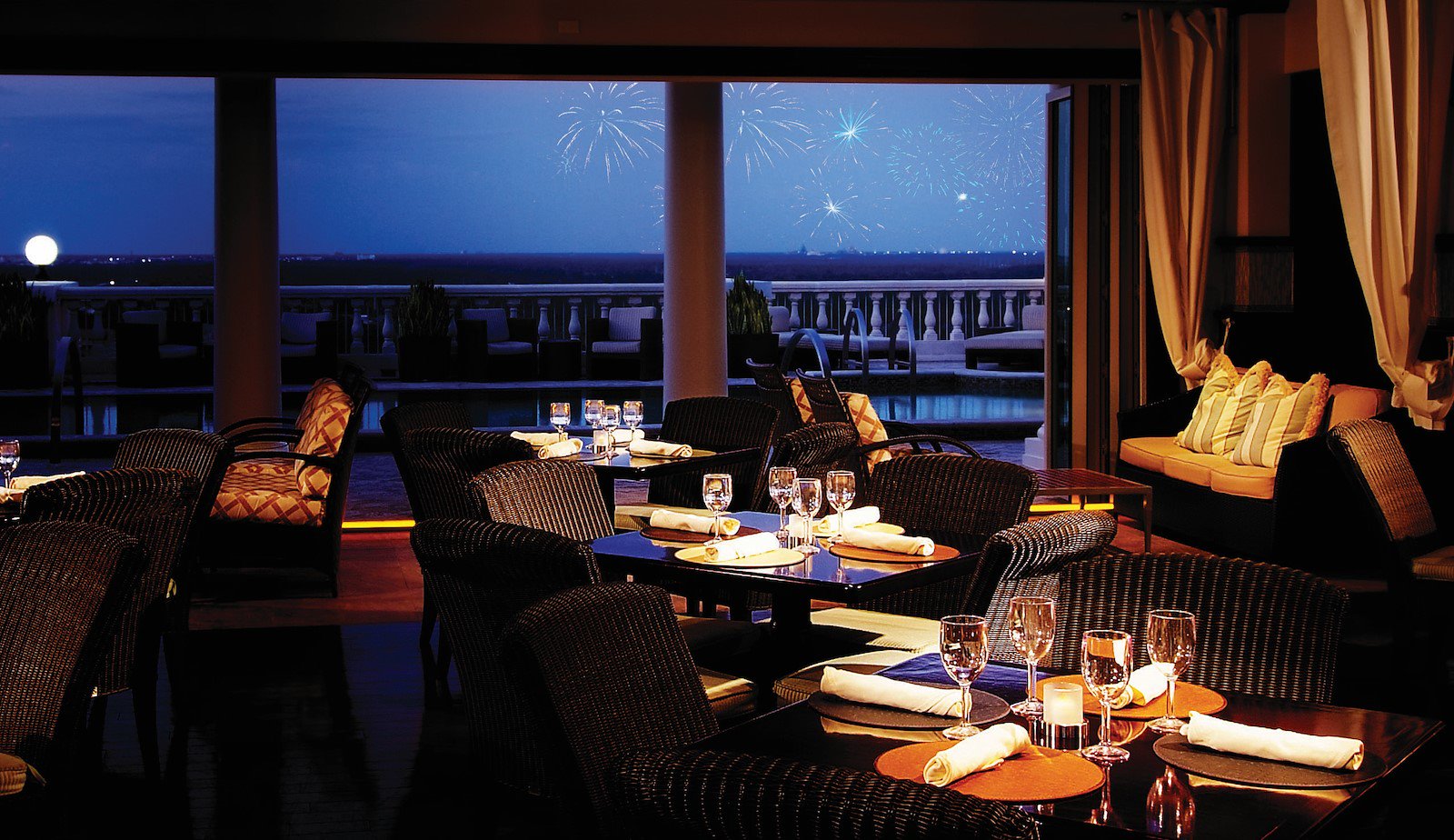 An evening view from inside of the Eleven restaurant located in Reunion Resort of the nighttime fireworks.