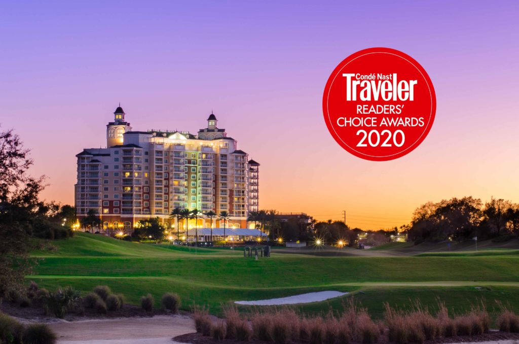 Sunset photo of Reunion Grande to the left, overlooking the golf course. Red circular logo that reads "Condé Nast Traveler Readers Choice Awards 2020" placed on the sky portion of photo to the right.