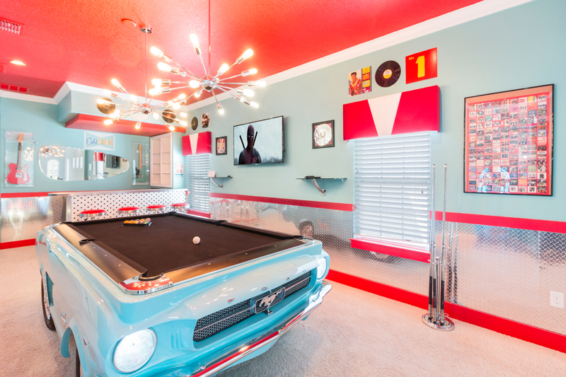 The game room featuring a sky blue classic Mustang pool table inside of Designed for Vacation (RVH_320M) inside of Reunion Resort. Kissimmee, Florida.